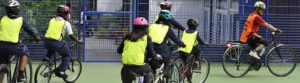 A group of pupils follow an instructor on the playground